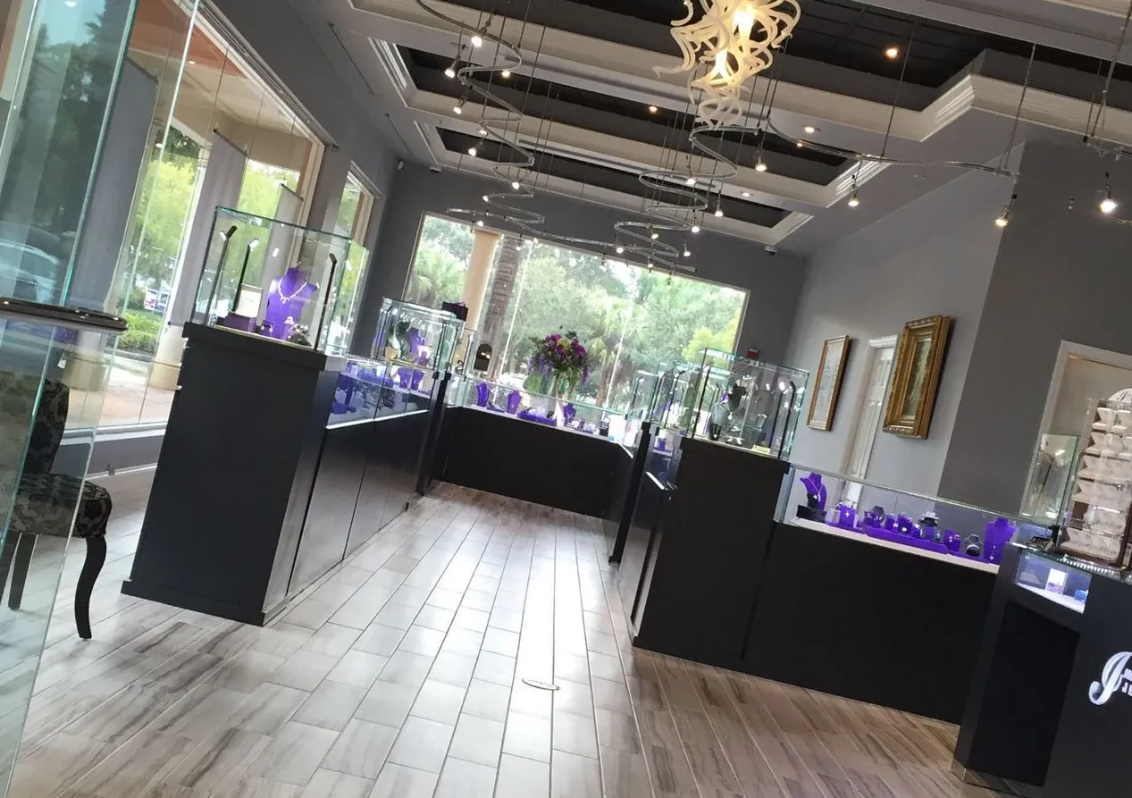 The International Jewelers showroom at The Promenade, with glass cases and a glass chandelier